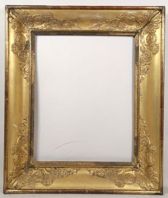 a gold framed mirror with ornate design on a white wall