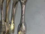 five forks and two spoons on the table