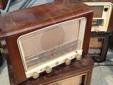 two old fashioned radio ' s sitting on top of each other