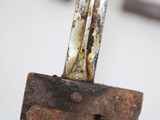 a rusted piece of metal that has been placed on top of a piece of wood