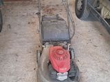 a lawn mower that is sitting in the garage
