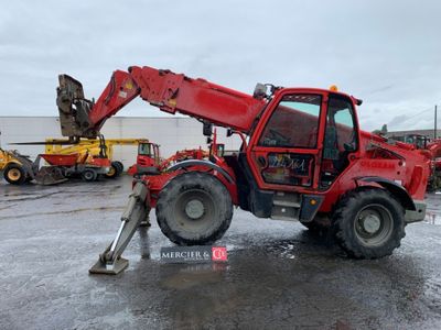 a red tractor that is parked in the parking lot