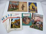 several children ' s books are sitting on a white surface