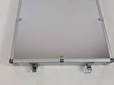 an image of a metal box with wheels on a white surface