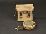 a small box with a cord attached to it on a black surface