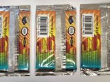 three packets of candy sitting on a white surface