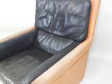 a black leather chair that is on a white background