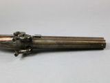 an old gun that is sitting on top of a table