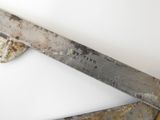 a knife that is sitting on top of a sheet of paper