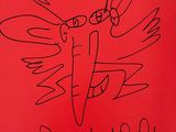 un livre rouge sur lequel est dessiné un oiseau