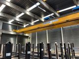 an overhead crane in a warehouse with lots of steel poles