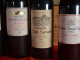 several bottles of wine are lined up on a table