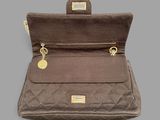 the brown purse is open on a gray surface