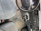 a car dashboard with a steering wheel and a bag on it