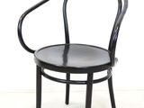 an image of a black chair against a white wall