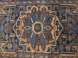 an image of a blue and brown rug with a design on it