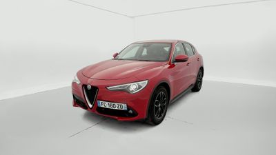 a red alfa car parked in a white room
