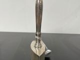 an image of a silver metal object on a black table