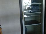 a refrigerator that is sitting in a room with a sign on the wall
