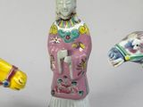 three chinese figurines of a woman and a horse on a white background