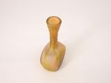 a small glass vase that is sitting on a white surface