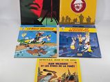 four books in french and english on a white background