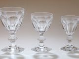 three empty wine glasses sitting on a table with a white background