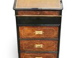 an image of a wooden chest of drawers with a leather top
