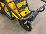 a yellow scooter that is parked in a garage