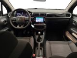 the interior of a small car with a steering wheel and dashboard