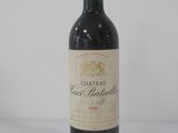 bottle of red wine on a white surface