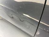 a close up of a car door with scratches on it