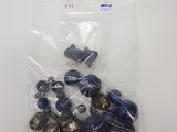 a bunch of buttons in a bag on a table