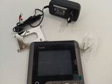 a tablet computer sitting on a table next to a charger and a charger