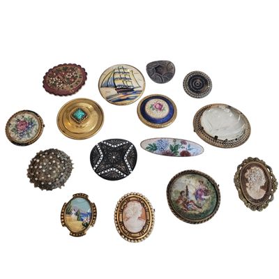 a lot of brooches that are on a white surface