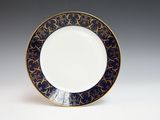 an image of a blue and gold plate on a white surface