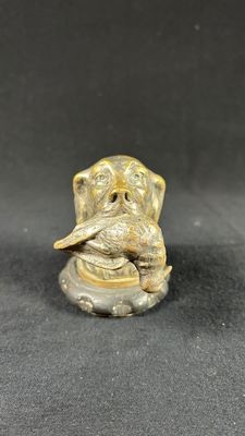 a close up of a figurine of an elephant on a black surface