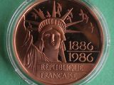 a close up of a coin with a statue of liberty on it
