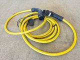 a couple of yellow hoses sitting on top of a cement floor