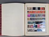 an open book with stamps on it sitting on a table
