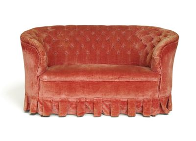 a red couch with a ruffled skirt on it