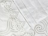 a close up of a white table cloth with a design on it