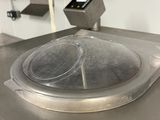 stainless steel counter top in a commercial kitchen with a glass lid