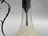two silver and glass vases sitting next to each other