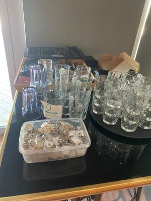 a table with a lot of glasses and a tray of cookies on it
