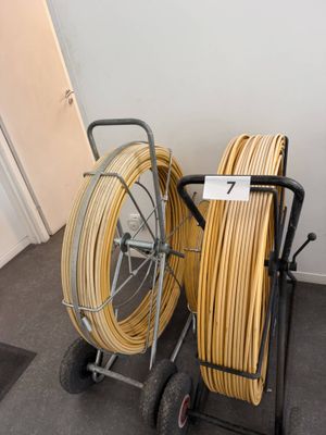a cart with a lot of hoses on it in a room