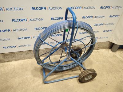 an image of a blue hose cart with wheels in a room
