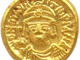 a close up of a gold coin on a white surface