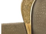 a gold colored bed with a heart shaped headboard on it