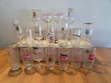 a lot of wine glasses sitting on a wooden table